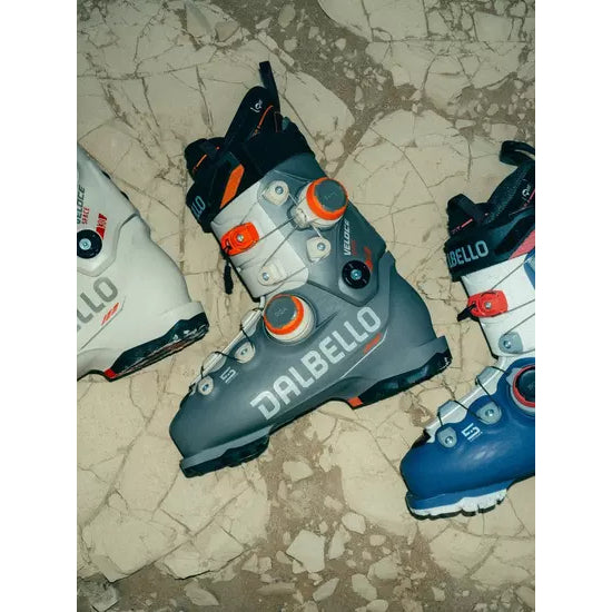 Dalbello Veloce Space boots in teal and blue colourways laid out on stone