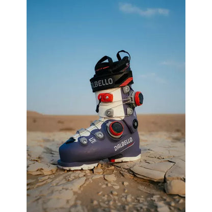 A Dalbello Veloce Space boot in a purple colourway standing on desert rock
