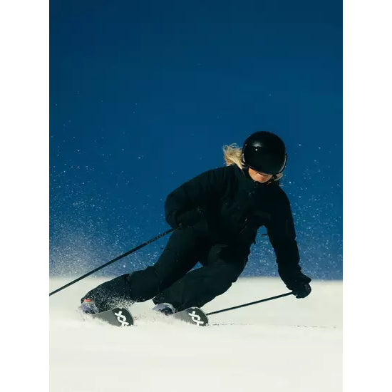 A skier carving on firm snow