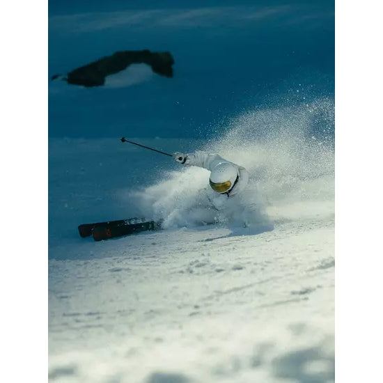A skier making a turn through soft snow