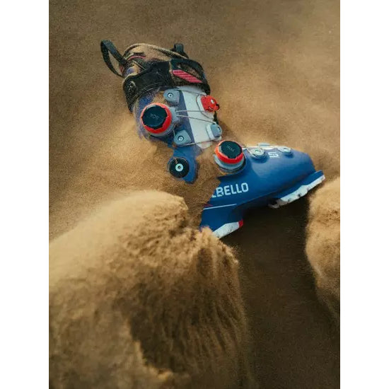 A Dalbello Veloce Space boot in a blue colourway resting in sand